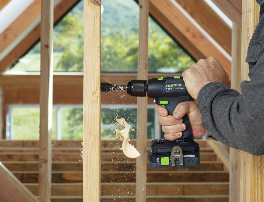 Festool powertool drilling through wood.